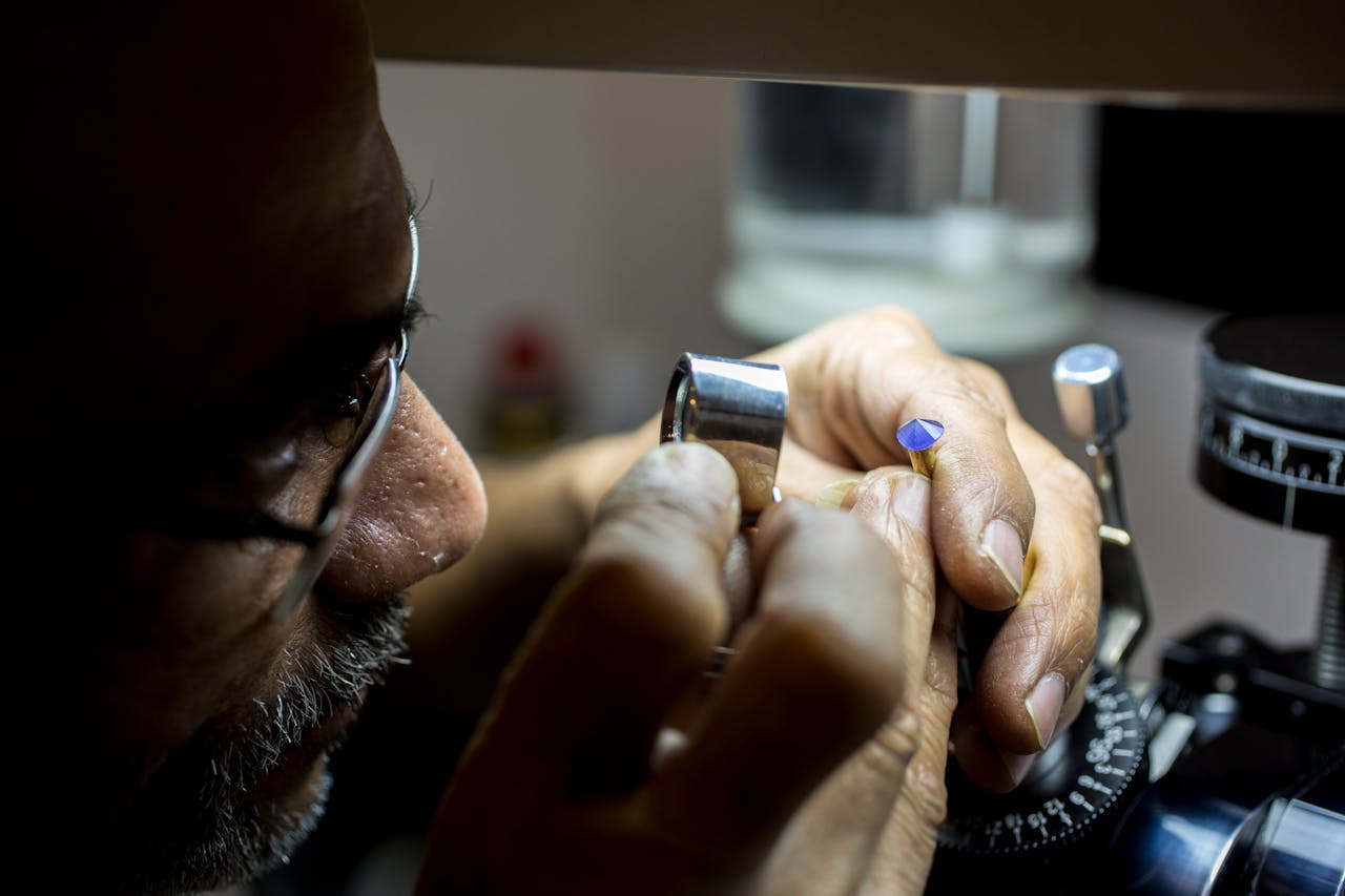 Close-up of a jeweler inspecting a gemstone in Dubai, highlighting precision and craftsmanship.